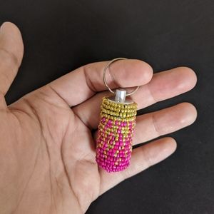 Pink and golden Beaded portable pill case keychai.